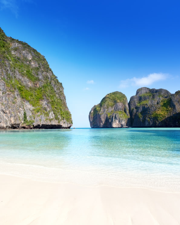 White sand beach and turquoise water framed by limestone cliffs at Maya Bay on Phi Phi Leh Island, Thailand