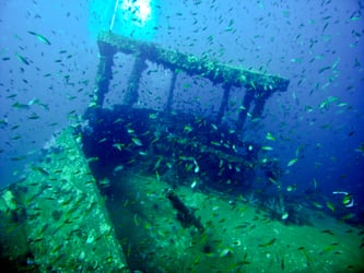 Marine life swimming around the wheelhouse of the King Cruiser Wreck near Phuket, Thailand