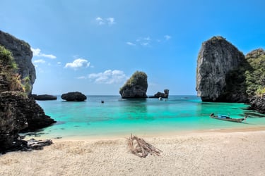Tropical beach with turquoise water and limestone islands off the coast of Phi Phi, Thailand